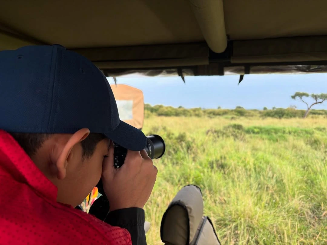visitors taking photos at masai mara reserve
